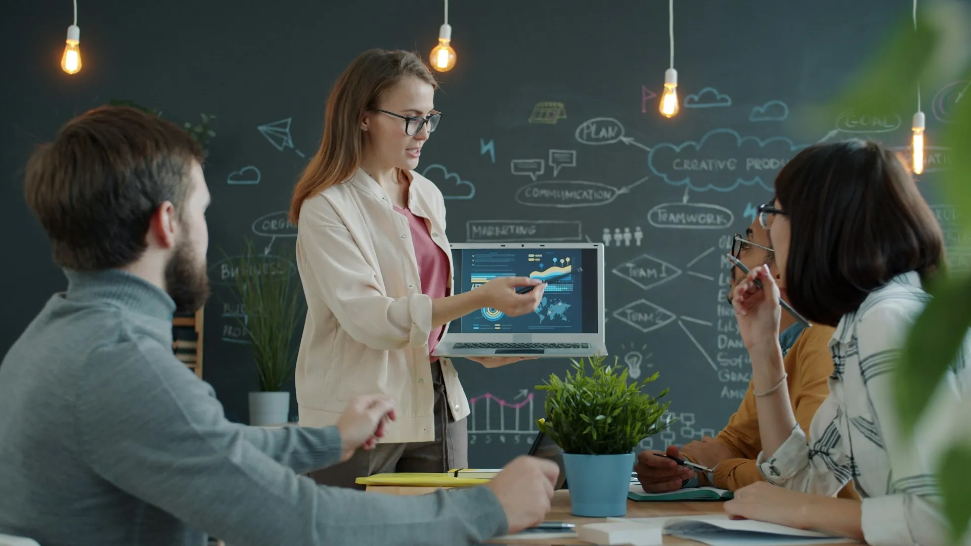 Finance consultant presenting a business strategy on a laptop dashboard